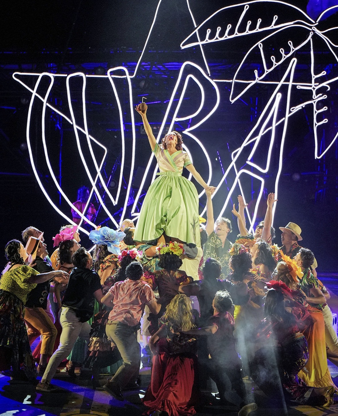 Once on This Island — leading lady in green dress under neon palms