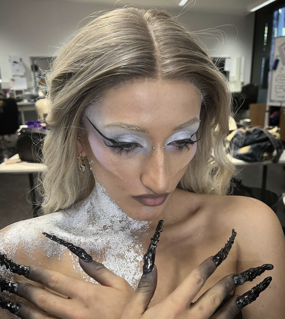 Music video beauty — icy eye, silver body shimmer and sculpted black nails