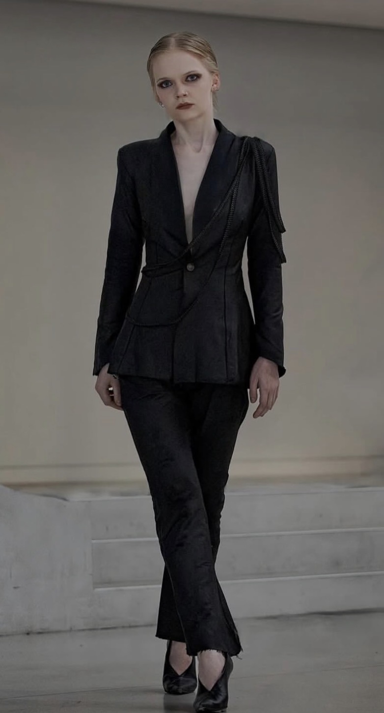 Runway portrait — black tailored suit with dark eye and lip