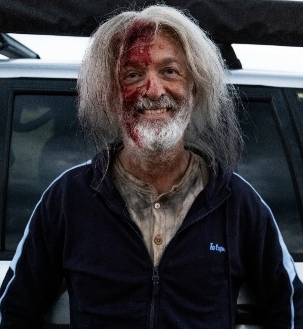 Film character — bloodied survivor with grey hair