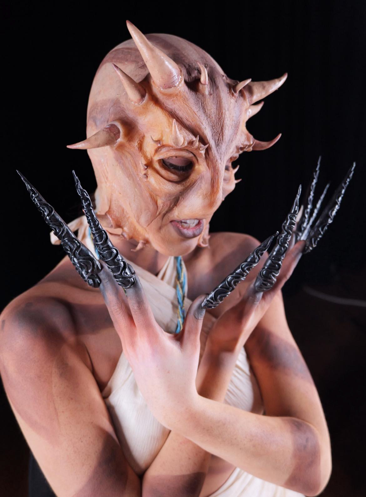 Horned mask with ornate black claws